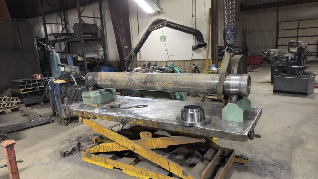 Large steel pipe assembly on the fabrication table at Engineered Welding near Monticello Iowa