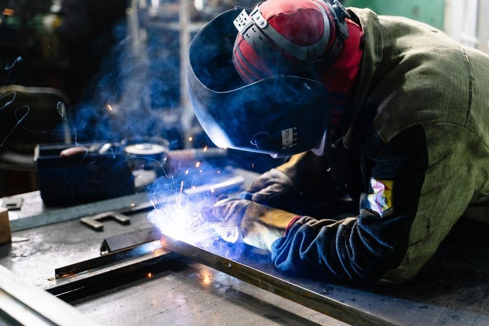 Certified welder performing MIG welding on structural steel